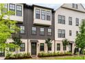 Attractive townhouse exterior with a mix of white brick and dark wood accents offers modern charm at 6635 Beacon Dr, Atlanta, GA 30328
