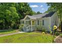 Landscaped front yard and inviting exterior with a charming yellow front door at 1539 Marbut Se Ave, Atlanta, GA 30316