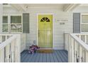Close up of the front porch with a yellow door, East Atlanta sign, and flower decorations at 1539 Marbut Se Ave, Atlanta, GA 30316