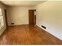 Inviting living room with hardwood floors, large windows, and neutral paint at 2703 Arrowood Dr, East Point, GA 30344
