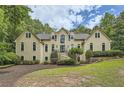Stately home with symmetrical design, many windows, and lush landscaping at 5940 Plantation Dr, Roswell, GA 30075