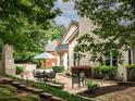 An inviting outdoor space with stone patio, complete with dining set and lush surroundings for ultimate relaxation at 5940 Plantation Dr, Roswell, GA 30075