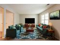 Bright living room featuring stylish seating, a modern rug, and a large screen television for entertaining at 1851 Grove Way, Hampton, GA 30228