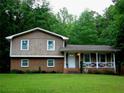 Charming two-story home with a brick and wood facade and a welcoming front porch at 2592 King Louis Ne Rd, Conyers, GA 30012