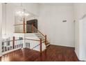 Open-concept living room with hardwood floors, a staircase with wooden railing, and natural lighting at 4096 Audubon Dr, Marietta, GA 30068