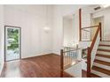 Bright living room boasting high ceilings, hardwood floors, a fireplace, and large windows overlooking the yard at 4096 Audubon Dr, Marietta, GA 30068