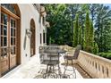 Charming balcony with wrought iron seating area offers a serene outdoor retreat with views of lush greenery at 4309 Sentinel Post Nw Rd, Atlanta, GA 30327