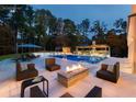 Beautiful pool area with a lounge area, fire pit, cabana, outdoor kitchen, and diving board at 4309 Sentinel Post Nw Rd, Atlanta, GA 30327