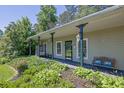 Inviting covered front porch with seating, perfect for enjoying the well-manicured landscaping at 530 Chicapoo Dr, Marietta, GA 30066
