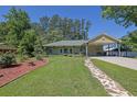 Beautifully landscaped front yard with lush green grass and a stone pathway leading to the charming home at 530 Chicapoo Dr, Marietta, GA 30066