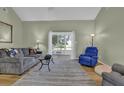 Bright living room with hardwood floors, neutral walls, and a view into the sunroom at 530 Chicapoo Dr, Marietta, GA 30066