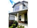 Inviting front porch with stone accents and supporting pillars on a sunny day at 2363 Bear Mountain St, Lithonia, GA 30058