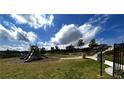 Community playground with slides, green grass, and shade trees for outdoor fun at 2363 Bear Mountain St, Lithonia, GA 30058