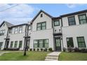 Inviting townhome featuring light brickwork, dark window frames, and professional landscaping at 2406 Lakeshore Ln, Atlanta, GA 30316