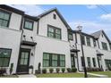 Beautiful townhome highlighting white brick, black trim, and a well-maintained front lawn at 2406 Lakeshore Ln, Atlanta, GA 30316