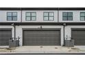 Attached garages featuring gray doors and matching trim at 2406 Lakeshore Ln, Atlanta, GA 30316