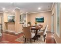 Formal staged dining room adjacent to kitchen, features elegant table and chairs at 1684 Tailmore Ln, Lawrenceville, GA 30043