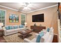 Cozy staged living room with large windows, comfortable seating, and modern decor at 1684 Tailmore Ln, Lawrenceville, GA 30043