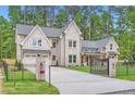 Beautiful white brick home featuring an attached garage and a private gated driveway at 2625 Beverly Ln, Snellville, GA 30078