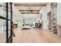 Expansive living room with hardwood floors, exposed beams, and a brick fireplace at 2625 Beverly Ln, Snellville, GA 30078