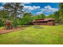 Expansive backyard featuring a playground and beautiful green grass at 2905 Cammie Wages Rd, Dacula, GA 30019