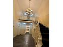Elegant entryway featuring a chandelier, staircase, and classic architectural details at 6851 Roswell Rd # D33, Atlanta, GA 30328