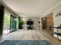 Open living room with hardwood floors, sliding glass doors to balcony, and neutral color scheme at 6851 Roswell Rd # D33, Atlanta, GA 30328