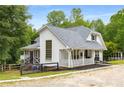 Stylish white home with a cozy porch and an attached screened-in porch at 999 Bailey Rd, Woodstock, GA 30188