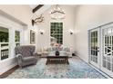 Bright living room featuring high ceilings, large windows, and stylish furnishings at 999 Bailey Rd, Woodstock, GA 30188