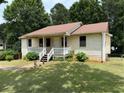 Quaint single-story home with a cozy front porch and a lush green lawn at 285 Woodland St, Dallas, GA 30157