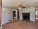 Spacious living room featuring a stone fireplace and a classic ceiling fan at 285 Woodland St, Dallas, GA 30157