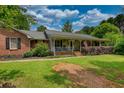 Attractive single-Gathering home boasting a welcoming front porch and lush landscaping for great curb appeal at 78 N Pomona Rd, Hampton, GA 30228