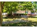 Inviting community park with a metal bench, lush green grass, and mature trees for relaxing outdoors at 1420 Baygreen Rd, Suwanee, GA 30024