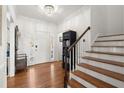 Inviting foyer with hardwood floors, staircase, and ample natural light showcasing the home's entrance at 220 Riverview Trl, Roswell, GA 30075