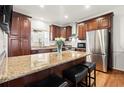 Gourmet kitchen with stainless steel appliances, granite countertops, and a large island with seating at 220 Riverview Trl, Roswell, GA 30075