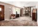 Spacious living room with a unique stone fireplace and ample natural light from a large window at 2209 Willoby Ct, Morrow, GA 30260