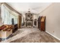 Open living area featuring a stone fireplace and neutral carpet, ready for personal touches at 2209 Willoby Ct, Morrow, GA 30260