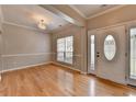 Elegant foyer with hardwood floors, decorative trim, and a stylish light fixture at 2477 Lakebrooke Dr, Marietta, GA 30066