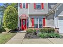 Inviting front entrance features a red door and manicured landscaping at 2477 Lakebrooke Dr, Marietta, GA 30066