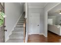 Inviting foyer with hardwood floors, a staircase, and neutral paint at 440 S Alexander St, Buford, GA 30518