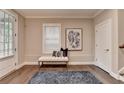 Stylish foyer featuring hardwood floors, a cozy bench, and a tasteful artwork, creating a welcoming ambiance at 221 Thompson St, Alpharetta, GA 30009