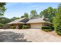 Lovely brick house featuring an attached garage and a beautifully paved driveway at 186 Mt Calvary Rd, Marietta, GA 30064