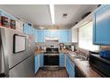 Efficient kitchen with blue cabinets, modern appliances, and ample counter space for meal preparation at 359 Dallas St, Hiram, GA 30141