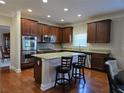 Modern kitchen with stainless steel appliances, granite countertops and a central island with breakfast bar at 3623 Terrah Point Dr, Duluth, GA 30097