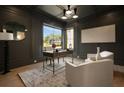 Stylish office with dark walls, large window, modern lighting, and comfortable seating area at 130 Nova Ln, Roswell, GA 30075