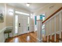 Bright foyer featuring hardwood floors, a staircase, and a view into other rooms at 417 S Candler St, Decatur, GA 30030