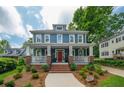 Inviting two-story home with a brick-accented front porch, classic architecture, and a well-manicured lawn at 417 S Candler St, Decatur, GA 30030