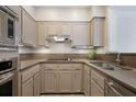Compact kitchen featuring ample cabinet space, stainless steel appliances, and sleek countertops at 175 15Th Ne St # 410, Atlanta, GA 30309