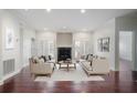 Bright living room with hardwood floors, fireplace, neutral decor, and double doors leading to an outdoor space at 175 15Th Ne St # 410, Atlanta, GA 30309