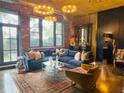 The living room has exposed brick walls, a large blue sofa, and stylish lighting at 3180 Mathieson Drive # 502, Atlanta, GA 30305